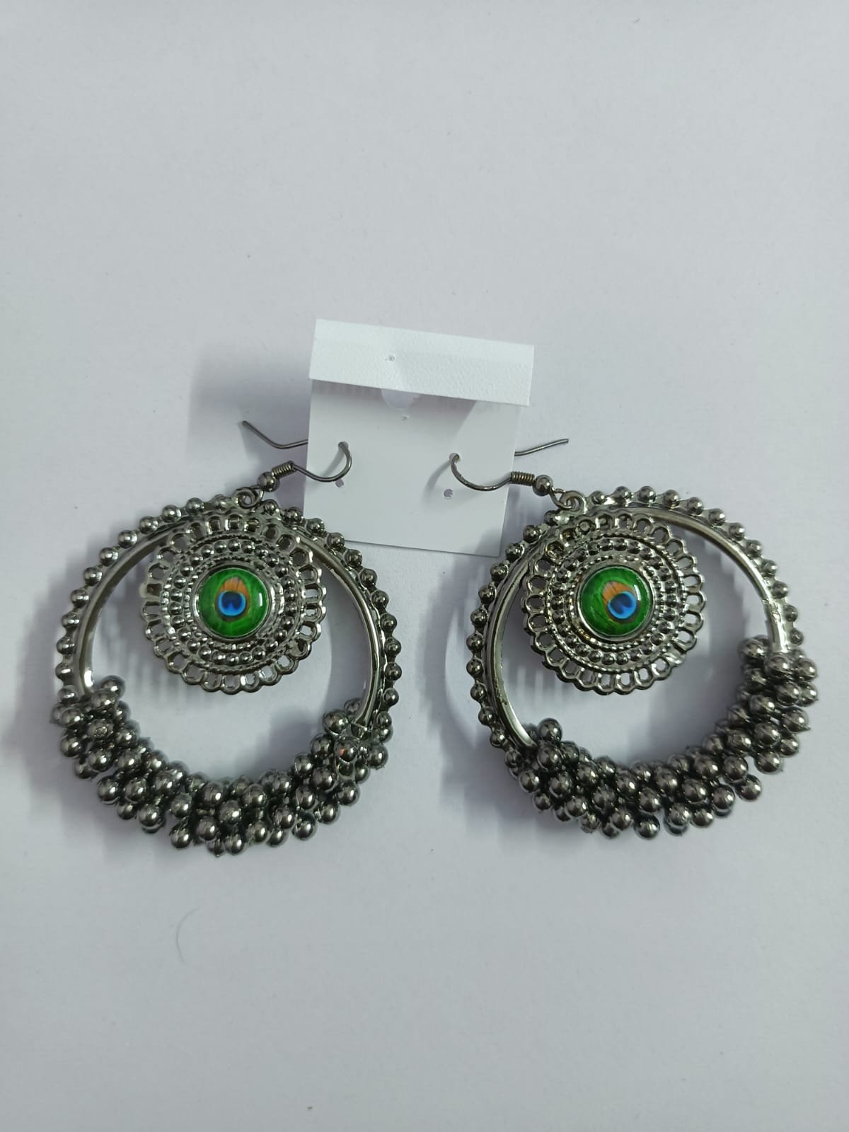 oxidized silver hoop earrings with peacock motif