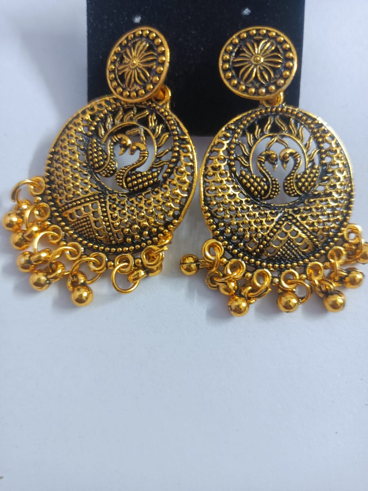 antique gold plated jhumka earrings with double peacock moti