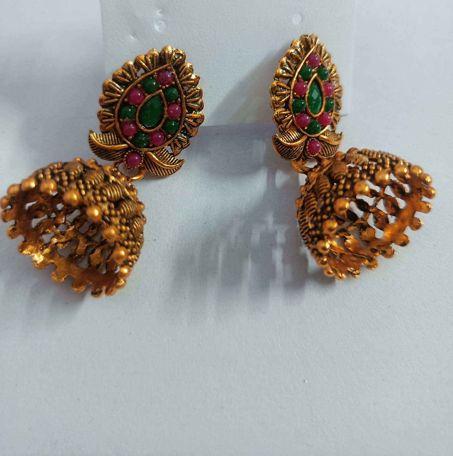 antique gold plated traditional jhumka earrings with floral embellishments